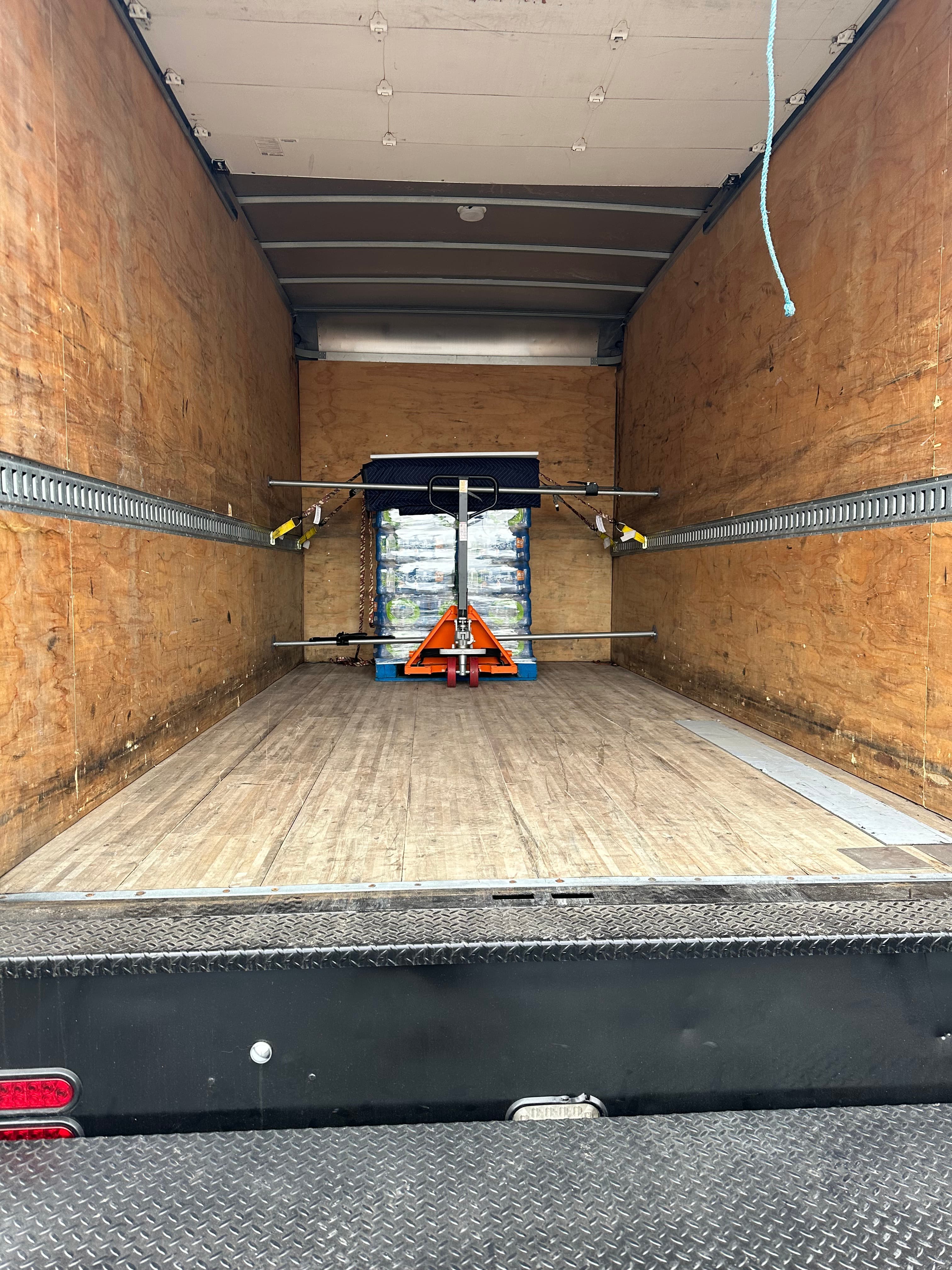 water bottle cases loaded inside a box truck